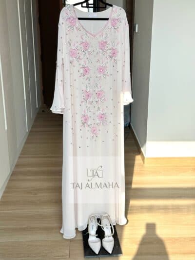 Elegant white dress with pink floral embroidery and gemstone accents, perfect for traditional or special occasions.