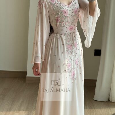 Elegant embellished pink and cream evening gown with floral embroidery and pearl accents.