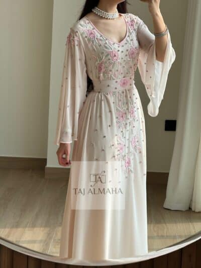 Elegant embellished pink and cream evening gown with floral embroidery and pearl accents.
