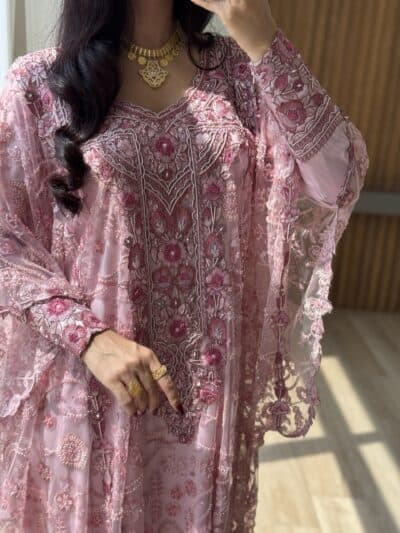 Intricate pink embroidered traditional dress featuring elaborate floral patterns and lace detailing.