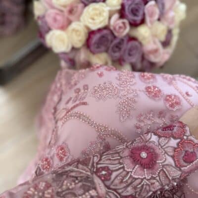 Elegant pink embroidered dress with floral patterns and sequins.