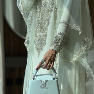 img_3907 Luxurious embroidered traditional dress with designer handbag showcasing elegance and style at Taj Al Maha.
