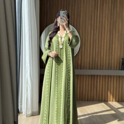 Elegant green embroidered kaftan showcasing traditional Moroccan fashion, perfect for special occasions.