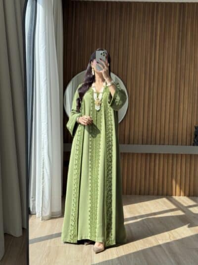 Elegant green embroidered kaftan showcasing traditional Moroccan fashion, perfect for special occasions.