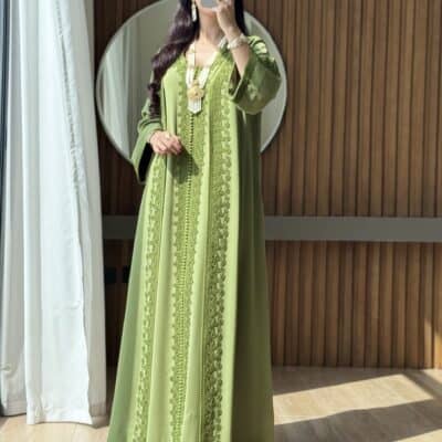 Luxurious green embroidered traditional dress for women at Taj Al Maha.