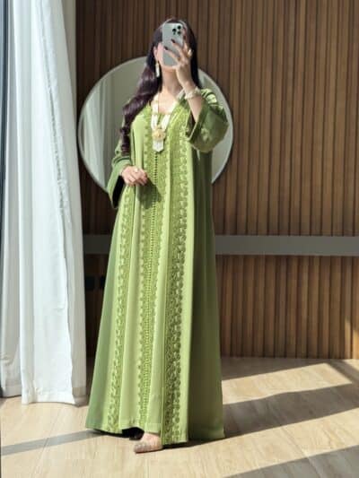 Luxurious green embroidered traditional dress for women at Taj Al Maha.