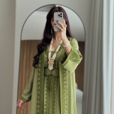 Elegant green traditional dress with intricate embroidery and accessories at Taj Al Maha.
