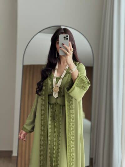 Elegant green traditional dress with intricate embroidery and accessories at Taj Al Maha.