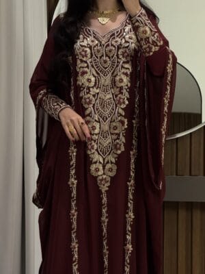 Elegant maroon traditional dress with intricate gold embroidery for special occasions.