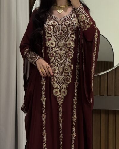 Elegant maroon traditional dress with intricate gold embroidery for special occasions.