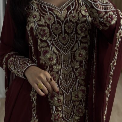 Elegant maroon embroidered traditional outfit with gold and silver intricate floral beadwork.