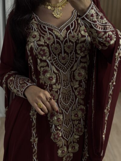 Elegant maroon embroidered traditional outfit with gold and silver intricate floral beadwork.