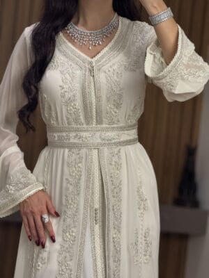 Elegant white embroidered wedding dress with intricate silver details, perfect for special occasions.