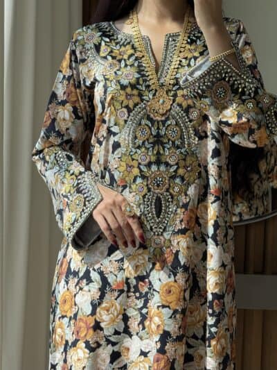 Elegant embroidered floral dress showcasing intricate gold and silver embellishments, perfect for special occasions.