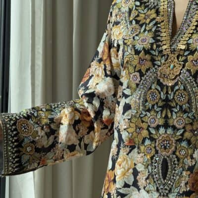 Elegant embroidered floral dress with intricate gold and beadwork for traditional wear.