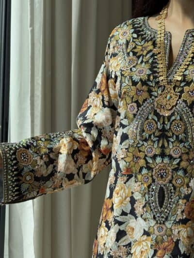 Elegant embroidered floral dress with intricate gold and beadwork for traditional wear.