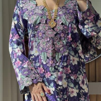 Luxurious floral embroidered dress with intricate beadwork and vibrant colors for elegant occasions.