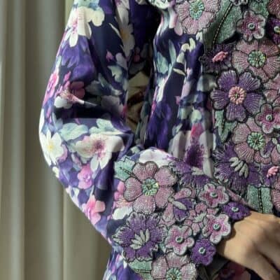 Vibrant floral embroidered dress with intricate beadwork and colorful flower patterns.