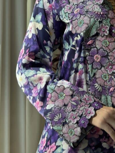 Vibrant floral embroidered dress with intricate beadwork and colorful flower patterns.