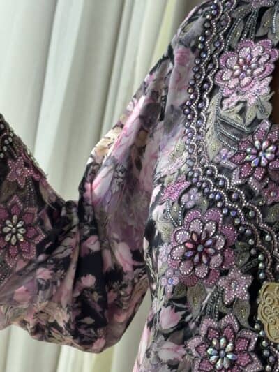 Luxury embroidered floral dress with intricate beadwork and pink floral print, designed by TAJ ALMAHA for elegant occasions.