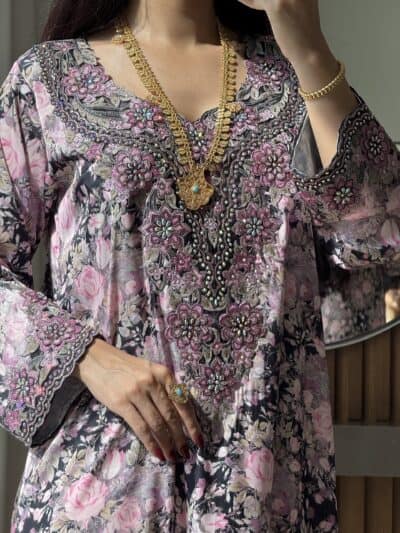 Intricate floral embroidered traditional dress with gold jewelry for cultural events.