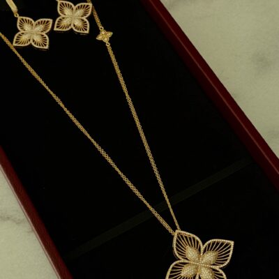 Elegant gold butterfly jewelry set featuring necklace and matching earrings.