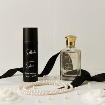 Elegant perfume and body spray products from Taj Al Maha with pearls and black ribbons, showcasing luxury and sophistication.